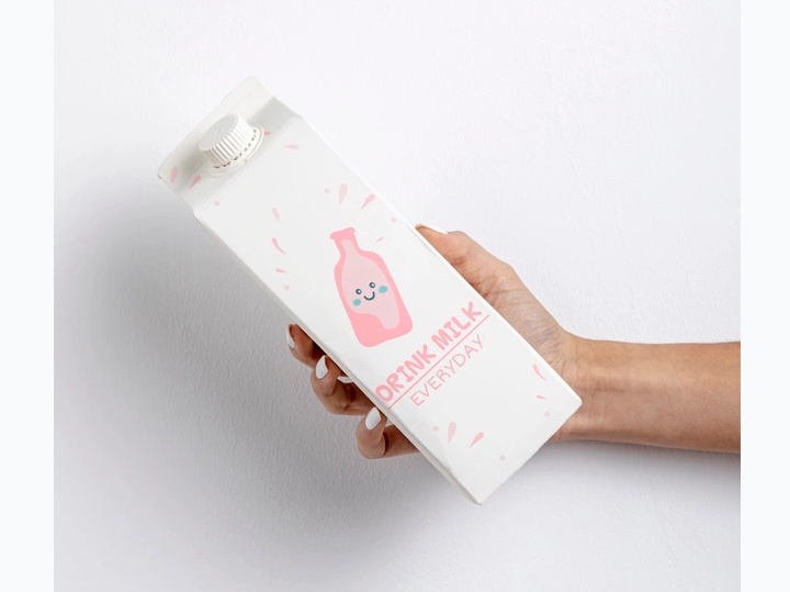 Milk Carton in Hand Mockup PSD