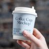 Free Coffee Cup in Hand Mockup