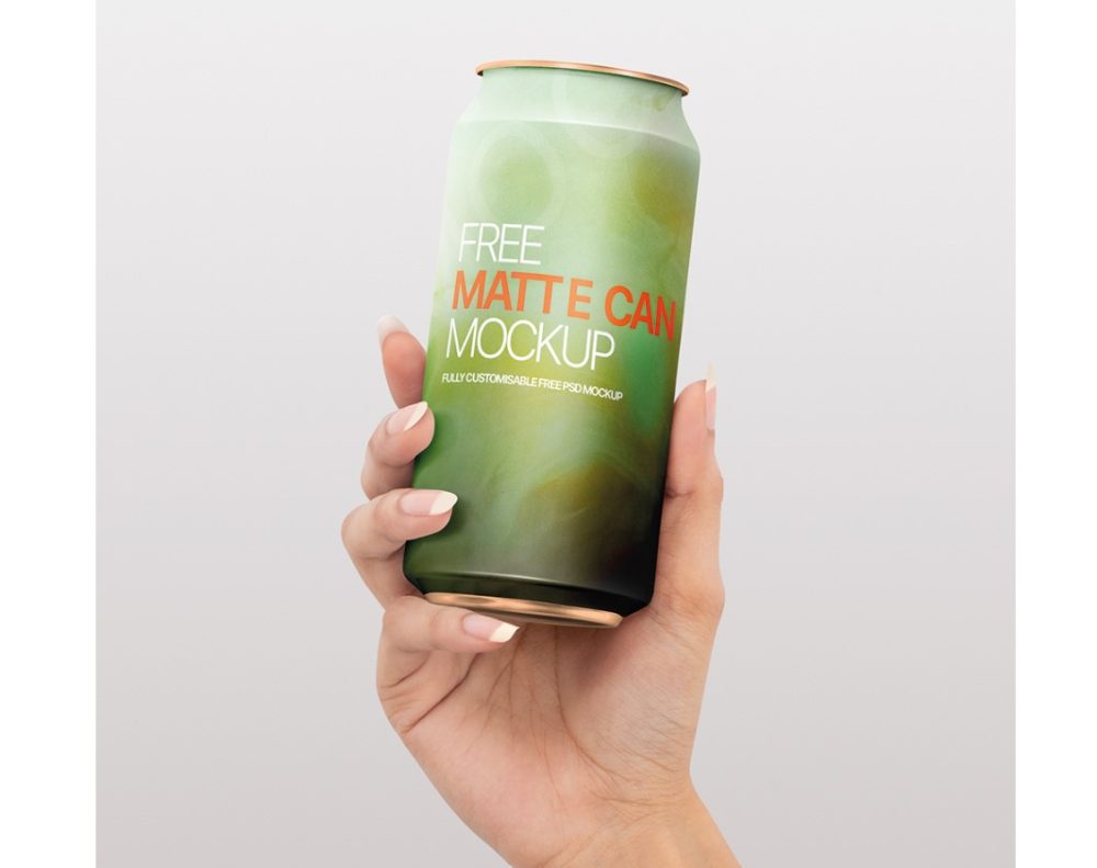 Free Soda Can in Hand Mockup